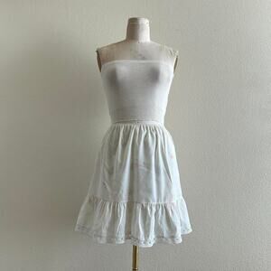 handmade white cotton mini skirt with pink floral embroidery and ruffle bottom